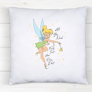 May include: White square pillow featuring a cartoon illustration of Tinkerbell with a wand. The image includes the text "All You Need Is Faith Trust And Pixie Dust" in black script. The character is in a green dress with blue wings.