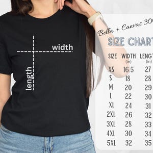 May include: A black t-shirt with a size chart printed on the right side. The chart lists sizes XS to 5XL, with corresponding width and length measurements in inches. The shirt is made of Bella + Canvas 3001 material.