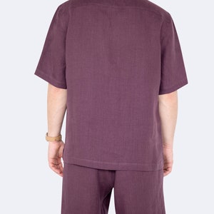 Model showing back of mens eggplant color linen shirt and shorts set