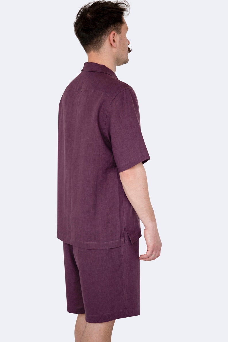Model wearing mens eggplant color linen shirt and shorts set, side view