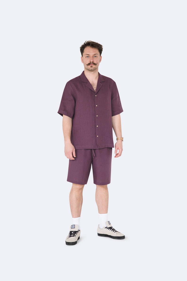 Full front view of model in mens eggplant color linen shirt and shorts set
