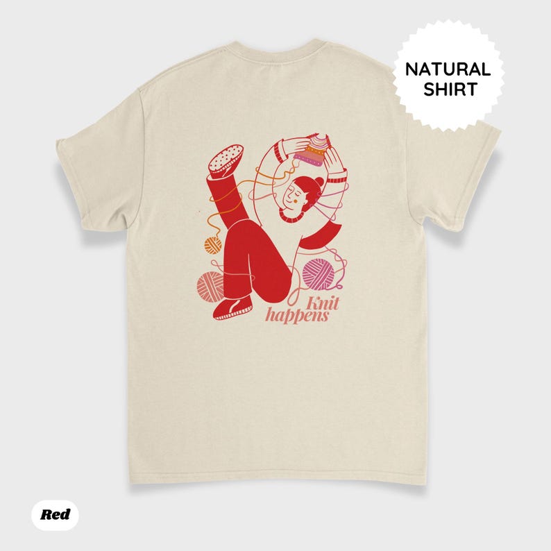 May include: Cream-colored t-shirt with a red graphic of a person knitting, surrounded by yarn balls. The text "Knit happens" is below the graphic. The shirt has a "Natural Shirt" label and a "Red" label.
