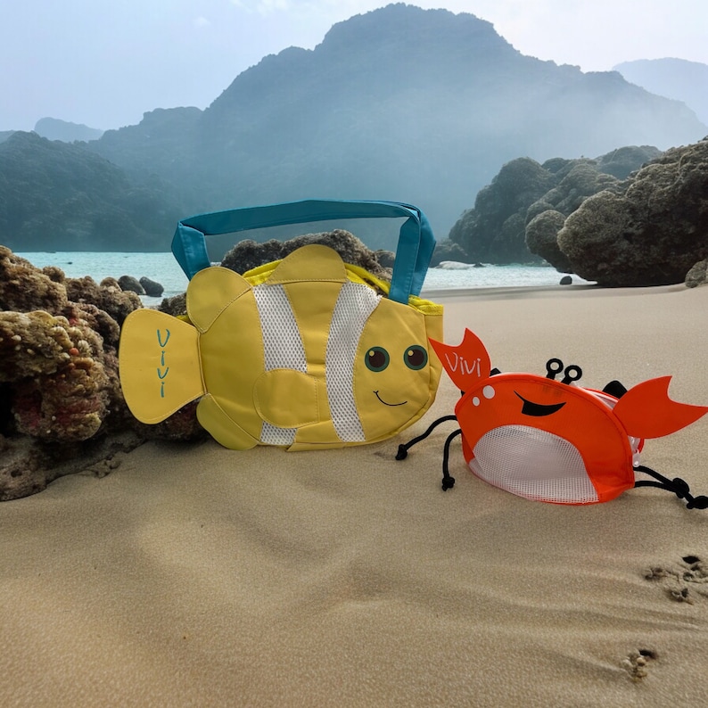May include: A yellow and blue fish-shaped beach bag with the word "vivi" on it, and a red and orange crab-shaped beach bag with the word "vivi" on it.