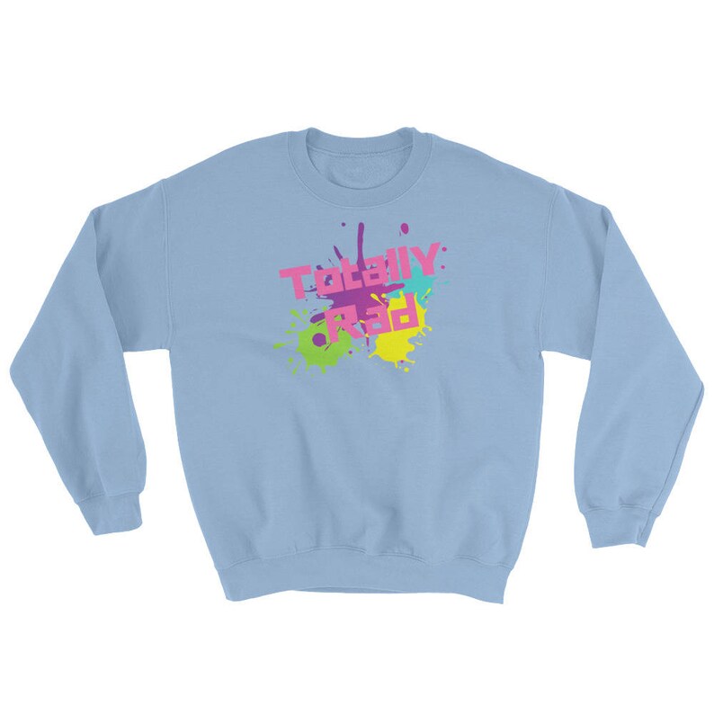 May include: Light blue sweatshirt with the words "Totally Rad" in pink, yellow, and purple, with colorful paint splatter design. The sweatshirt is a crew neck style.