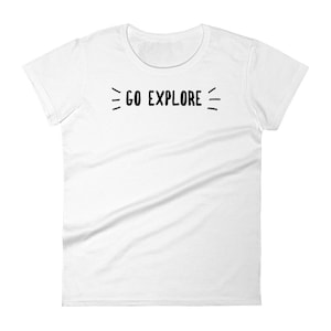 May include: White t-shirt with the text "GO EXPLORE" in black, centered on the chest. The text is flanked by three short lines on each side. The shirt has a crew neck and short sleeves.