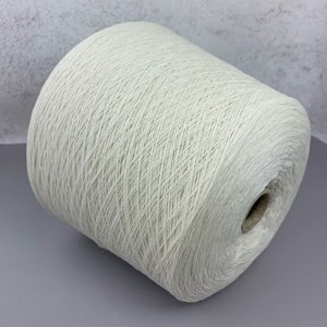May include: A skein of off-white yarn wound on a cardboard tube.