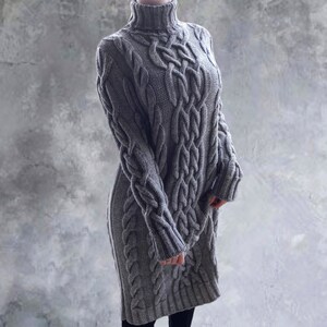 May include: A gray cable knit sweater dress with a turtleneck.