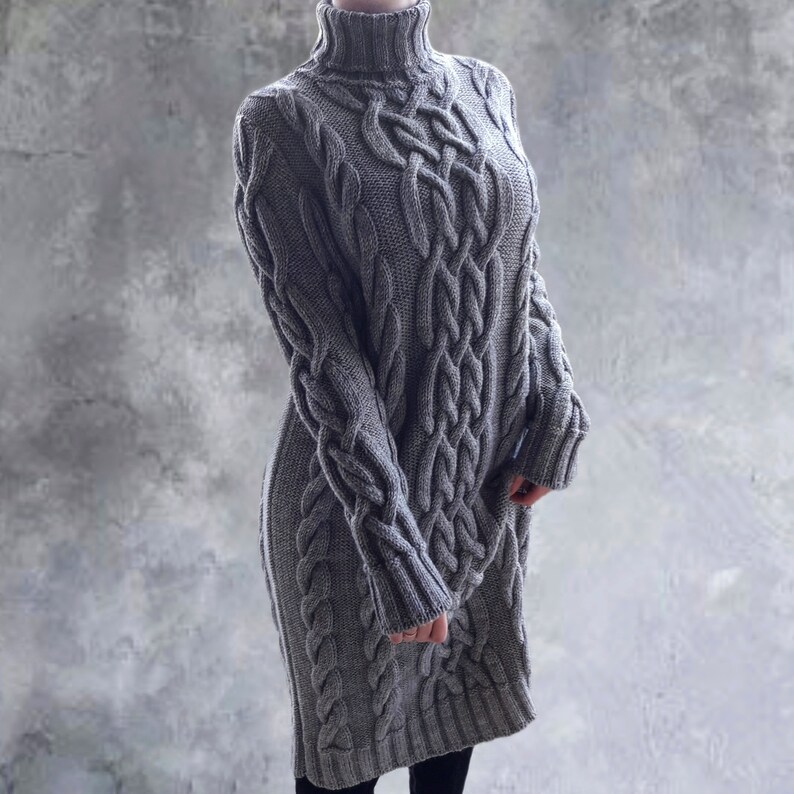 May include: A gray cable knit sweater dress with a turtleneck.