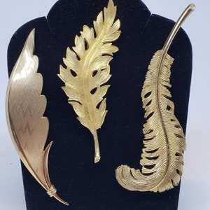 Signed CORO Vintage Set of Three Pins Two are Leaves and One is a Feather Plume