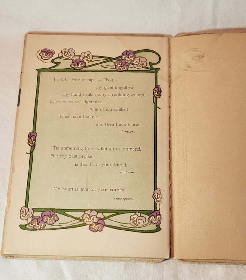 May include: Open book with a poem on the left page. The poem is framed with a green border and floral accents in purple and white. The text includes the words "Friendship!" and "Shakespeare."