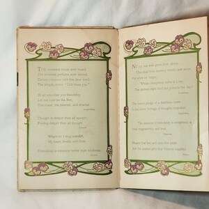 May include: Open book with two pages of poetry. Each page has a green border with floral designs in purple and white. The text is in a classic font, with poems about friendship and love.