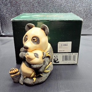 May include: A hand-painted porcelain figurine of a mother panda bear holding her cub. The panda bears are sitting on a bed of bamboo. The figurine is part of a limited edition collection and is numbered 0215/5000. The box reads "Wild Birds Unlimited" and "Gentle Giant Limited Edition".