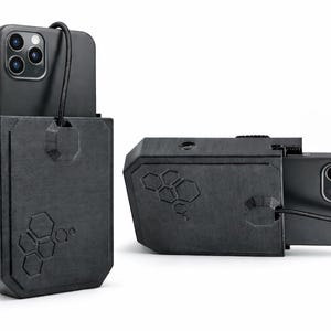 May include: Two black phone cases with a geometric design. One case is upright, and the other is on its side, both with a phone inside. The cases have a textured surface and a lanyard. The cases are designed to protect the phone.
