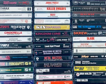May include: A collection of vintage cassette tapes featuring various artists, including AC/DC, Alice Cooper, Black Sabbath, Cinderella, Deep Purple, and many more. The tapes are arranged in rows and are all in their original cases.
