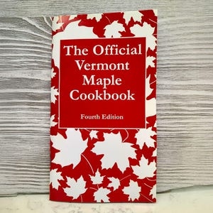 May include: The Official Vermont Maple Cookbook, Fourth Edition, red cover with white maple leaf design.