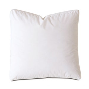 May include: A white, square pillow with a smooth, cotton-like texture. The pillow is filled with a soft, fluffy material and has a simple, classic design.