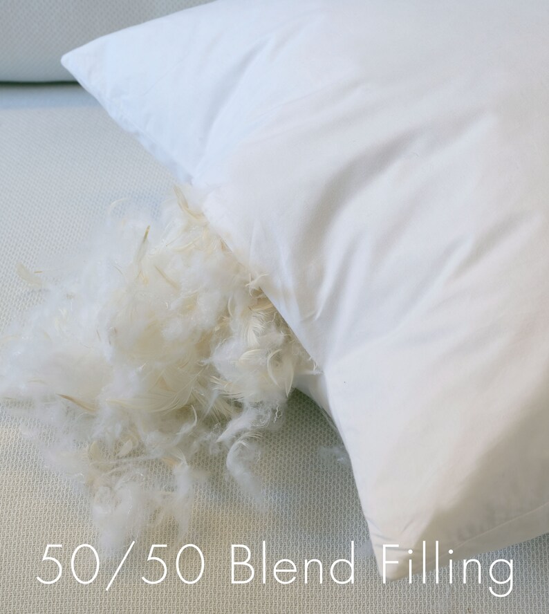 May include: A white pillow with a 50/50 blend filling. The pillow is open and the filling is spilling out.