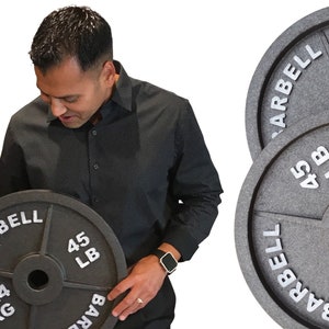 May include: A set of three black cast iron weight plates. The plates are 45 pounds each and have the words "BARBELL" and "45 LB" printed on them. The plates are stacked on top of each other.