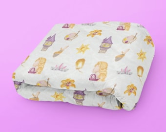May include: A white folded blanket with a repeating pattern of a purple tower, a yellow sun, a yellow flower, a yellow lantern, and a blonde woman with a purple dress.