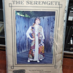 May include: A vintage sewing pattern for a patchwork vest, titled "The Serengeti" by Roberta Whitworth. The pattern features a woman wearing the vest in a photo.