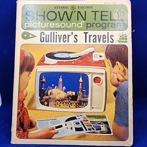 May include: Vintage General Electric Show 'N Tell picturesound program box featuring "Gulliver's Travels." The box has a retro design with a red and white television set illustration and the text "Prince & the Pauper."