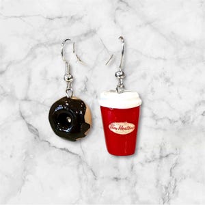 May include: A pair of dangle earrings featuring a chocolate glazed donut and a red Tim Hortons coffee cup.