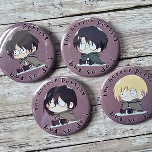 May include: Four round purple buttons with anime-style character illustrations. Each button features a different character with dark hair, wearing a cape, and the text "the horror persist but so do i".