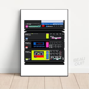 May include: A framed print depicting a retro audio system illustration. The artwork presents a stack of black stereo units with vibrant displays and buttons. The print includes the text "LX-70 AIWA", "MX-70 AIWA", "FX-70 AIWA", and "BEAU OUI?"