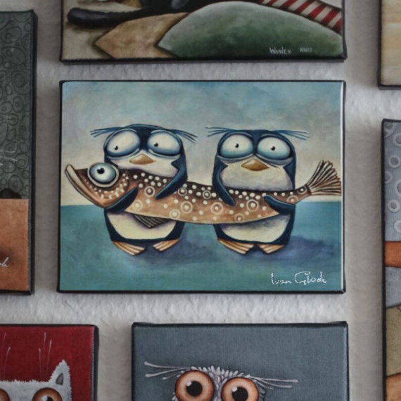 May include: Two cartoon penguins with large eyes and beaks are carrying a brown and white fish with black spots. The fish is longer than the penguins. The background is a light blue. The painting is signed "Ivan Glod".