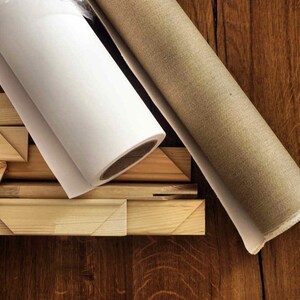 May include: A roll of white canvas, a roll of beige canvas, and wooden stretcher bars for creating a painting.