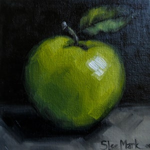 May include: A painting of a green apple on a dark background. The apple is painted in a realistic style with visible brushstrokes. The artist's signature, "Skee Mark", is visible in the lower right corner.