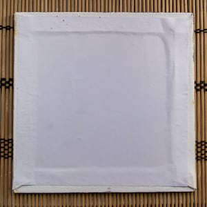 May include: A white canvas stretched over a wooden frame. The canvas is blank and ready for painting.