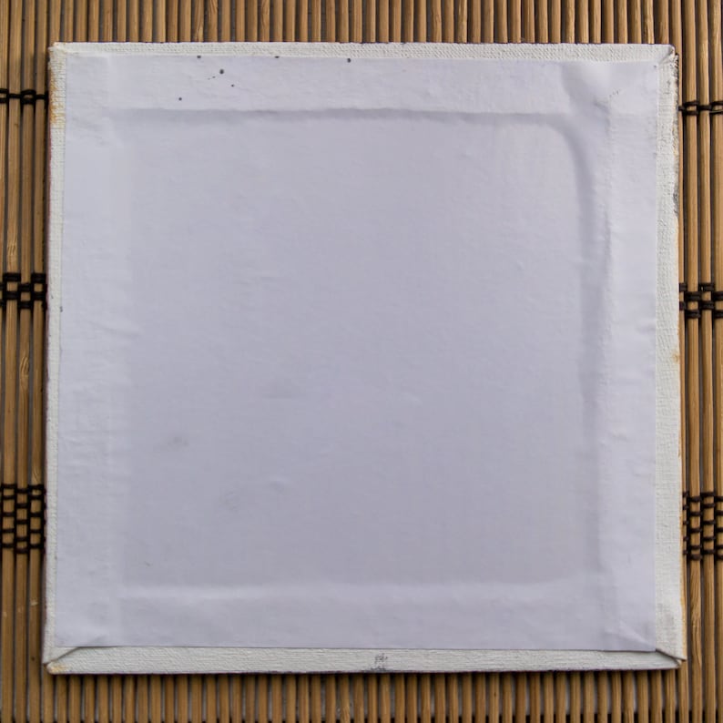 May include: A white canvas stretched over a wooden frame. The canvas is blank and ready for painting.