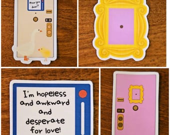May include: A collection of four stickers featuring designs from the TV show Friends. One sticker shows a yellow frame, another a pink door, and two others feature text: "How you doin?" and "I'm hopeless and awkward and desperate for love!"