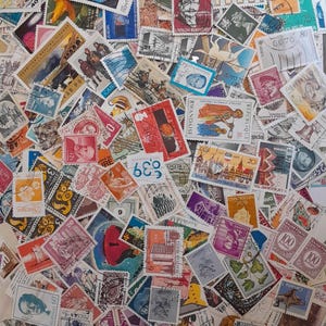 May include: A collection of colorful postage stamps from various countries and eras. The stamps feature diverse designs, including portraits, buildings, and abstract art. The stamps are arranged in a dense, overlapping pattern, showcasing a variety of colors and sizes.