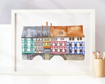May include: A framed watercolor painting depicting a row of five half-timbered houses with varying facade colors including green, brown, yellow, red, and blue. The buildings feature dark roofs and are situated above two stone arches.
