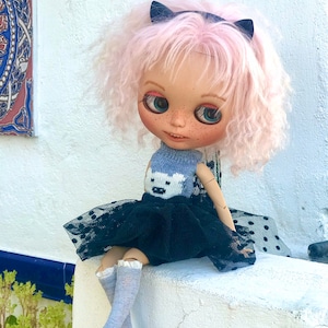 Blythe custom with jointed body and pink mohair hair.