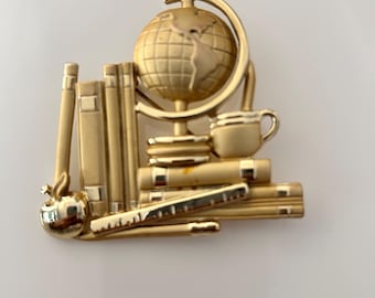 Broche vintage AJC dorado con útiles escolares