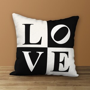 Peut inclure: Un oreiller noir et blanc avec le mot "LOVE" en grandes lettres audacieuses.
