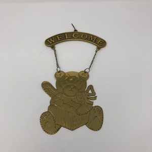 Vintage brass hanging welcome sign with teddy bear