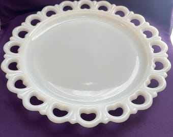 May include: White milk glass serving plate with a scalloped edge and a delicate openwork design.