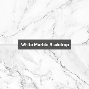 May include: White marble backdrop with a subtle veining pattern. This backdrop is perfect for product photography or creating a stylish background for your projects.