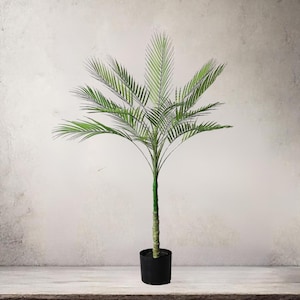 May include: A potted artificial palm tree with vibrant green fronds and a textured trunk. The plant is in a black pot, set against a neutral background. The palm tree is a decorative item for home or office.