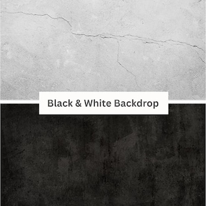 May include: A black and white backdrop with a textured surface. The top half is white with a crack running across it. The bottom half is black with a rough, uneven texture.