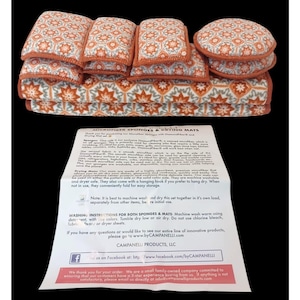 May include: A set of microfiber sponges and drying mats with an orange and white floral pattern. The set includes several rectangular mats and two round sponges. The text on the included paper reads "MICROFIBER SPONGES & DRYING MATS".