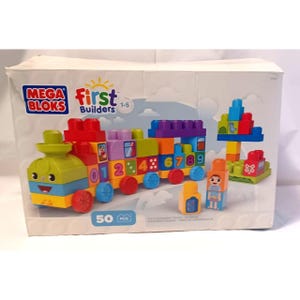 May include: A Mega Bloks First Builders 50-piece learning train set. The colorful train features numbered blocks from 0-9, along with additional building blocks and figures. The box displays the Mega Bloks and First Builders logos.