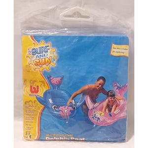 May include: A packaged Bestway Dolphin Boat, designed for children aged 3-6. The package features a blue and yellow design with the words "Surf and Sun." The inflatable boat has a see-thru window and measures 44 x 28 inches.