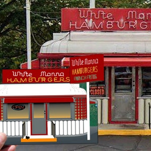 May include: A red and white diner with a sign that reads "White Mana Hamburgers". The diner has a red awning and a large window. There is a smaller version of the diner in the foreground, held by a hand. The smaller diner has a sign that reads "White Mana Hamburgers" and "Open".