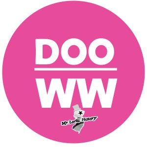 May include: A pink circle with the text "DOO WW" in white letters. Below the text is a small black and white illustration of a person wearing a top hat and holding a star. The text "Mr. Local History" is below the illustration.