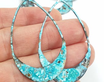 May include: Teardrop-shaped metal earring components with a distressed turquoise and brown finish. The open-frame design features a textured surface, perfect for jewelry making. Several pieces are visible, suggesting a set or collection.